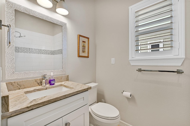13619 Windlass Cir, Galveston, TX 77554 - bathroom with toilet, vanity, a tile shower, and baseboards