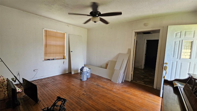 7622 Delavan Dr, Houston, TX 77028 - unfurnished living room with ceiling fan, hardwood / wood-style floors, and a textured ceiling
