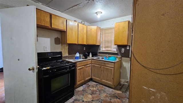 7622 Delavan Dr, Houston, TX 77028 - kitchen featuring black gas stove, a sink, a textured ceiling, and brown cabinets