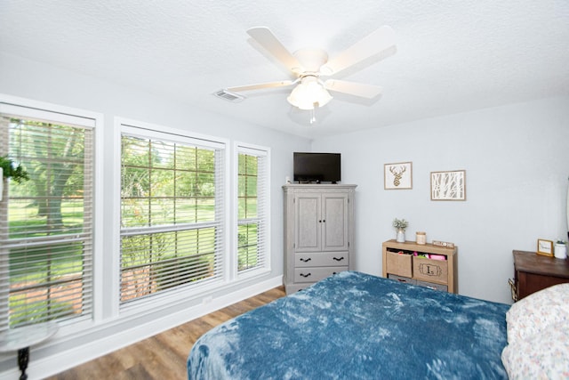 120 Brazos River Rd Unit 400, Freeport, TX 77541 - bedroom with wood finished floors and a ceiling fan