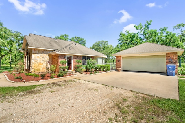 120 Brazos River Rd Unit 400, Freeport, TX 77541 - view of front of home featuring driveway, a garage, stone siding, and brick siding
