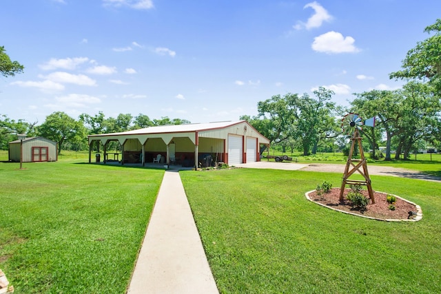 120 Brazos River Rd Unit 400, Freeport, TX 77541 - view of grassy yard featuring an outdoor structure, a garage, and concrete driveway
