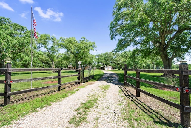 120 Brazos River Rd Unit 400, Freeport, TX 77541 - view of dirt / gravel driveway with a gated entry and a view of rural / pastoral area