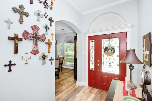 120 Brazos River Rd Unit 400, Freeport, TX 77541 - foyer with arched walkways, ornamental molding, and light wood-style flooring
