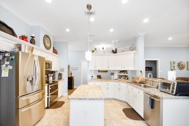 120 Brazos River Rd Unit 400, Freeport, TX 77541 - kitchen with stainless steel appliances, a center island, a peninsula, ornamental molding, and white cabinets