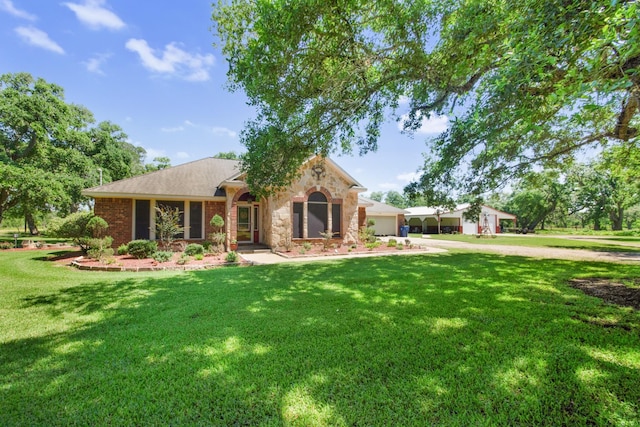 120 Brazos River Rd Unit 400, Freeport, TX 77541 - ranch-style home with an attached garage, a front lawn, brick siding, and driveway