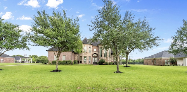 9030 Royal Crest Ln, Richmond, TX 77469 - french country style house with a front lawn, stone siding, and brick siding