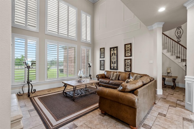 9030 Royal Crest Ln, Richmond, TX 77469 - living area featuring healthy amount of natural light, a high ceiling, stone tile floors, stairs, and recessed lighting