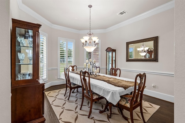 9030 Royal Crest Ln, Richmond, TX 77469 - dining space with a chandelier, wood finished floors, and crown molding