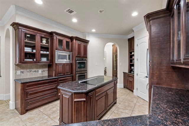 9030 Royal Crest Ln, Richmond, TX 77469 - kitchen with arched walkways, stainless steel appliances, ornamental molding, light tile patterned floors, and decorative backsplash