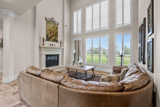 9030 Royal Crest Ln, Richmond, TX 77469 - living room with a tiled fireplace, a high ceiling, plenty of natural light, and ornamental molding