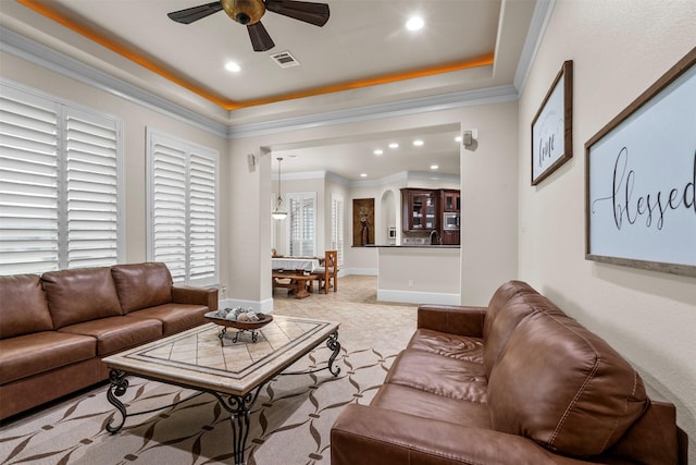 9030 Royal Crest Ln, Richmond, TX 77469 - living area featuring a ceiling fan, a tray ceiling, recessed lighting, crown molding, and light tile patterned flooring