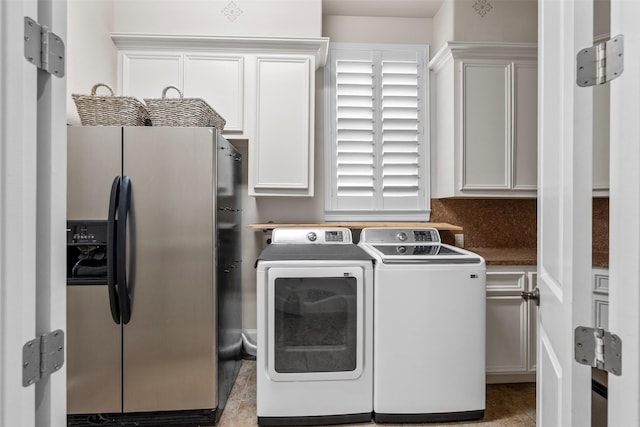 9030 Royal Crest Ln, Richmond, TX 77469 - laundry area featuring cabinet space, washing machine and clothes dryer, and light tile patterned floors