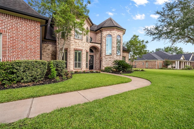 9030 Royal Crest Ln, Richmond, TX 77469 - french country inspired facade with a front lawn, brick siding, and stone siding