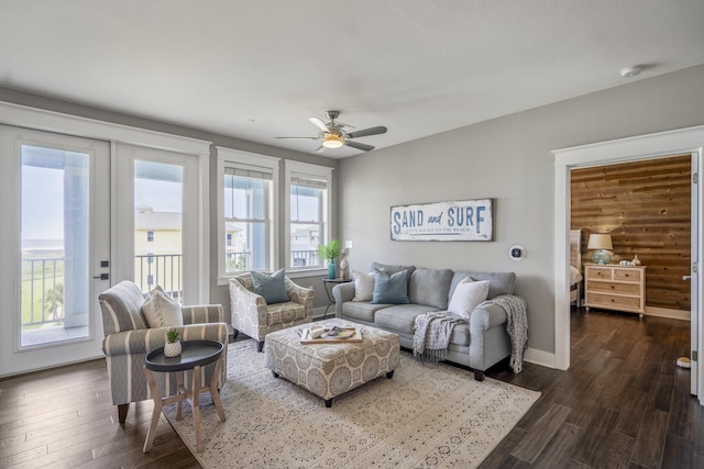 4221 Pointe W Dr Unit 302, Galveston, TX 77554 - living area featuring dark wood-type flooring, a ceiling fan, and baseboards