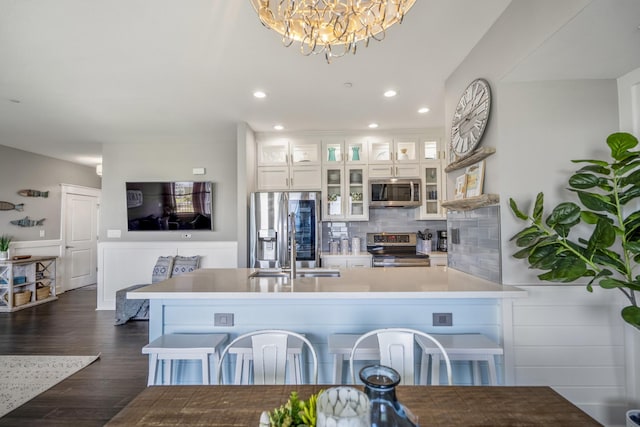 4221 Pointe W Dr Unit 302, Galveston, TX 77554 - kitchen featuring appliances with stainless steel finishes, a chandelier, recessed lighting, a sink, and decorative backsplash