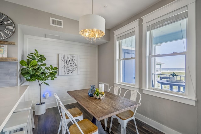4221 Pointe W Dr Unit 302, Galveston, TX 77554 - dining space with dark wood-style floors, baseboards, and a chandelier