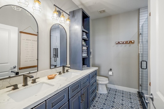 4221 Pointe W Dr Unit 302, Galveston, TX 77554 - bathroom featuring double vanity, toilet, an enclosed shower, baseboards, and tile patterned floors