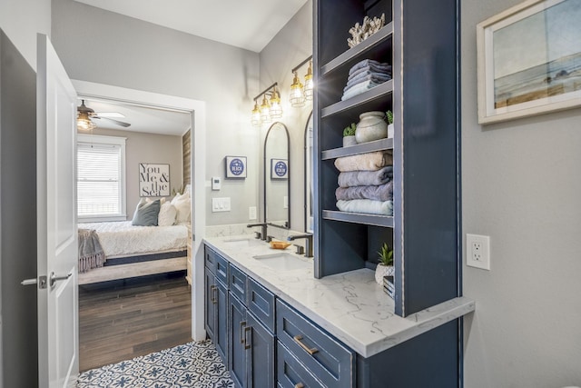 4221 Pointe W Dr Unit 302, Galveston, TX 77554 - ensuite bathroom with double vanity, ceiling fan, and wood finished floors