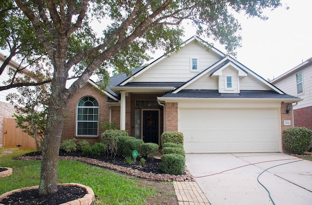 31010 Imperial Walk Ln, Spring, TX 77386 - view of front of house with brick siding, concrete driveway, a garage, and a shingled roof