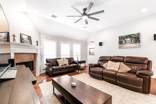 2911 Fair Chase Dr, Katy, TX 77494 - living room featuring lofted ceiling, ceiling fan, a tiled fireplace, wood finished floors, and recessed lighting