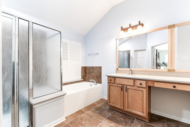 2911 Fair Chase Dr, Katy, TX 77494 - bathroom with vaulted ceiling, vanity, a garden tub, a shower stall, and baseboards