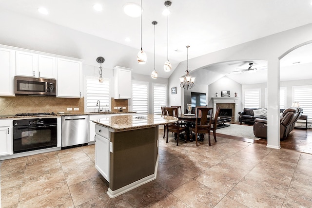 2911 Fair Chase Dr, Katy, TX 77494 - kitchen featuring appliances with stainless steel finishes, ceiling fan, a sink, healthy amount of natural light, and lofted ceiling
