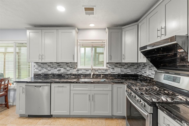 15119 Plaza Libre Dr, Houston, TX 77083 - kitchen featuring stainless steel appliances, a sink, decorative backsplash, dark stone counters, and recessed lighting