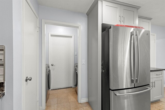 15119 Plaza Libre Dr, Houston, TX 77083 - kitchen featuring freestanding refrigerator, baseboards, and dark stone countertops