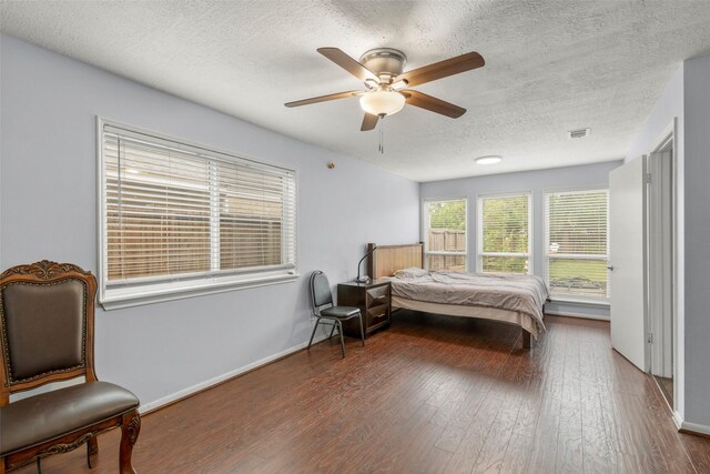 15119 Plaza Libre Dr, Houston, TX 77083 - bedroom featuring a textured ceiling, wood finished floors, a ceiling fan, and baseboards