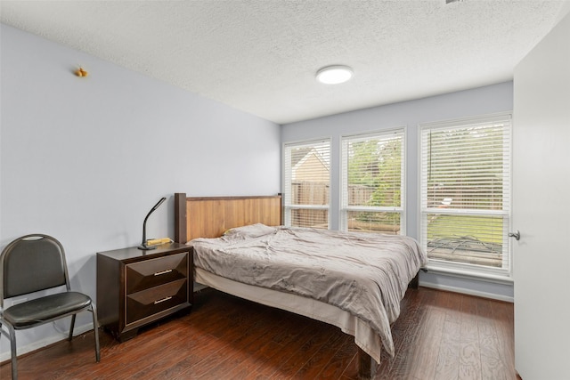 15119 Plaza Libre Dr, Houston, TX 77083 - bedroom featuring a textured ceiling and dark wood-style floors