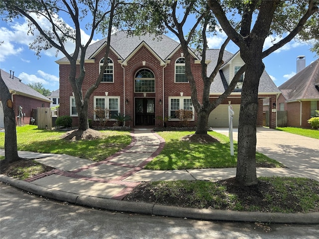 7111 Morrow Ct, Sugar Land, TX 77479 - traditional-style house with brick siding, concrete driveway, a front lawn, and a shingled roof