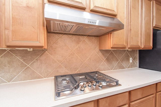 7111 Morrow Ct, Sugar Land, TX 77479 - kitchen with extractor fan, light countertops, stainless steel gas cooktop, and light brown cabinetry