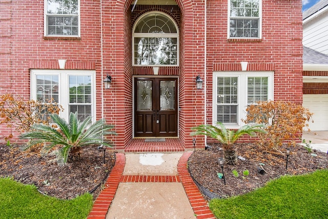 7111 Morrow Ct, Sugar Land, TX 77479 - property entrance with brick siding, french doors, and driveway