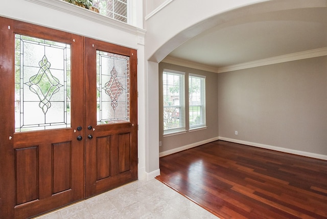 7111 Morrow Ct, Sugar Land, TX 77479 - foyer featuring arched walkways, french doors, ornamental molding, and wood finished floors