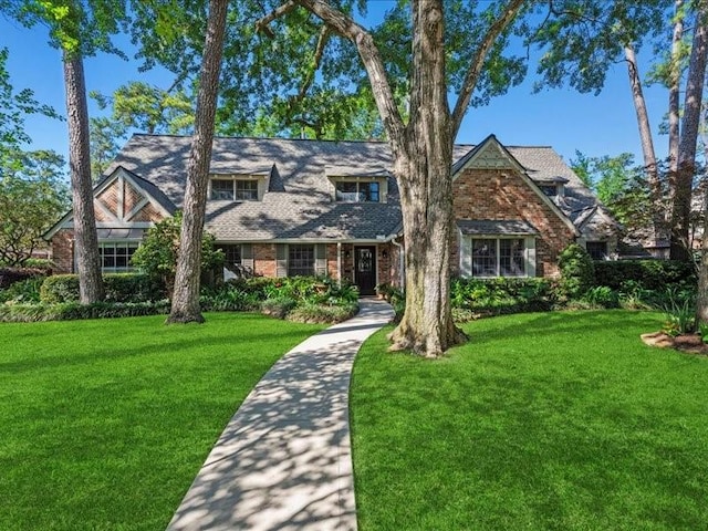 12214 Cobblestone Dr, Houston, TX 77024 - english style home featuring a front lawn and brick siding