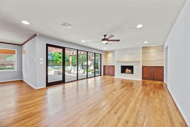 12214 Cobblestone Dr, Houston, TX 77024 - unfurnished living room featuring recessed lighting, light wood-style flooring, ceiling fan, baseboards, and a large fireplace
