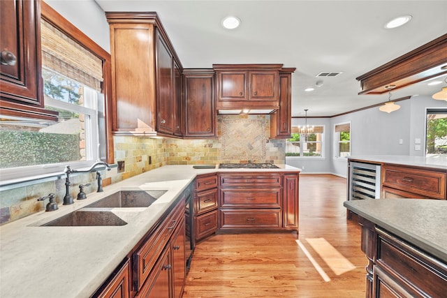12214 Cobblestone Dr, Houston, TX 77024 - kitchen featuring a sink, plenty of natural light, light wood finished floors, backsplash, and recessed lighting