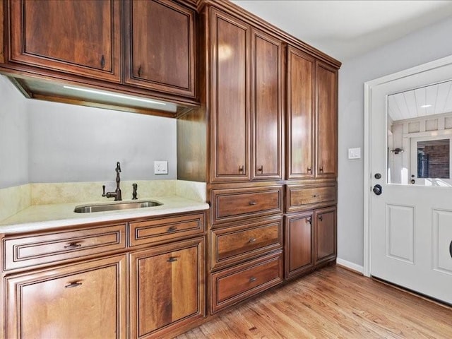 12214 Cobblestone Dr, Houston, TX 77024 - kitchen featuring a sink, light countertops, and light wood-type flooring