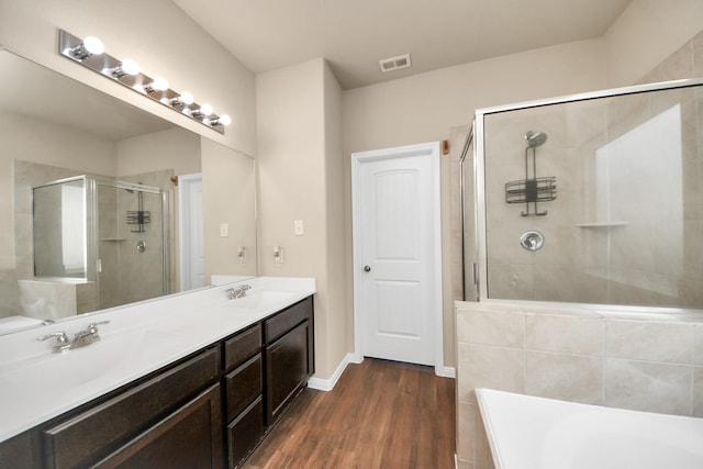 24739 Lorenzo Glaze Trl, Katy, TX 77493 - full bath with a stall shower, a garden tub, double vanity, wood finished floors, and baseboards