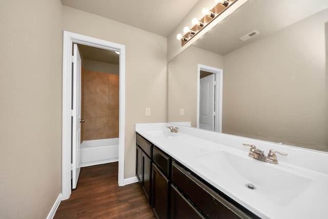 24739 Lorenzo Glaze Trl, Katy, TX 77493 - full bathroom featuring double vanity, wood finished floors, and baseboards