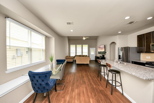 24739 Lorenzo Glaze Trl, Katy, TX 77493 - dining room featuring plenty of natural light, dark wood-type flooring, a ceiling fan, recessed lighting, and arched walkways