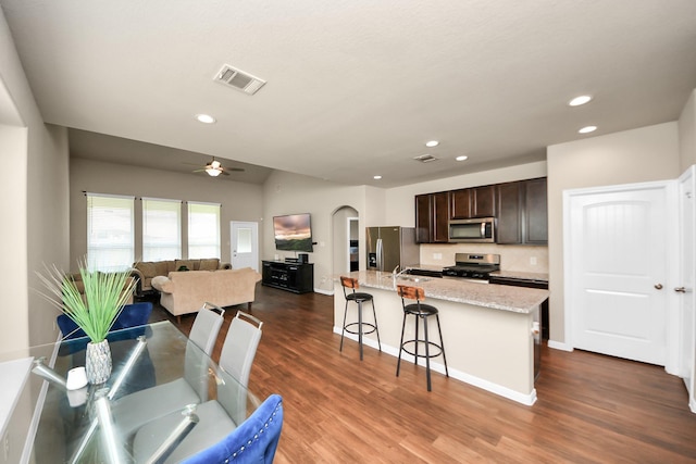 24739 Lorenzo Glaze Trl, Katy, TX 77493 - kitchen featuring appliances with stainless steel finishes, a sink, dark brown cabinets, dark wood-style flooring, and recessed lighting
