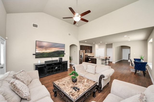 24739 Lorenzo Glaze Trl, Katy, TX 77493 - living room featuring arched walkways, a ceiling fan, dark wood-type flooring, and high vaulted ceiling