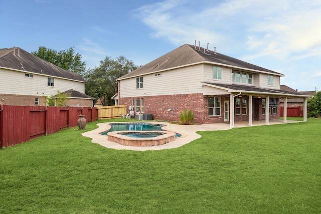 26402 Larkspur Ridge Dr, Katy, TX 77494 - rear view of property with brick siding, a patio area, cooling unit, and a pool with connected hot tub