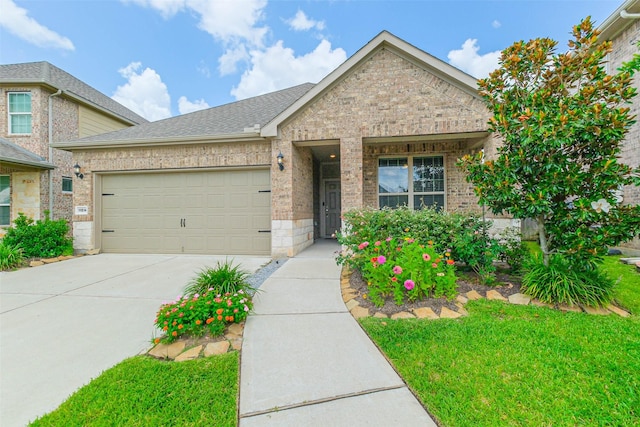11514 Harmony Summit Trce, Richmond, TX 77406 - view of front of home with brick siding, driveway, a garage, a shingled roof, and a front lawn