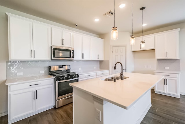 11514 Harmony Summit Trce, Richmond, TX 77406 - kitchen featuring stainless steel appliances, dark wood finished floors, a center island with sink, white cabinets, and recessed lighting