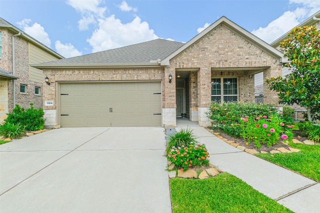 11514 Harmony Summit Trce, Richmond, TX 77406 - view of front of property featuring brick siding, an attached garage, driveway, and roof with shingles