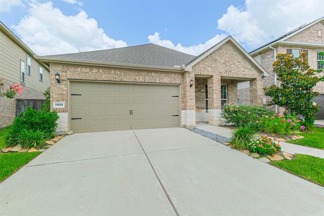11514 Harmony Summit Trce, Richmond, TX 77406 - view of front facade featuring brick siding, concrete driveway, a garage, and roof with shingles