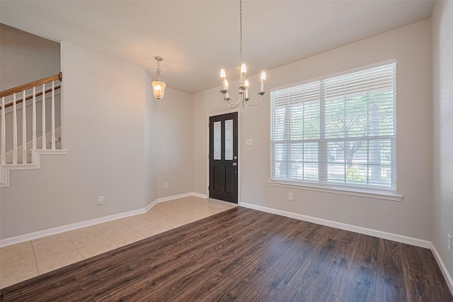 24523 Carlton Springs Ln, Katy, TX 77494 - entryway featuring wood finished floors, a chandelier, baseboards, and stairs